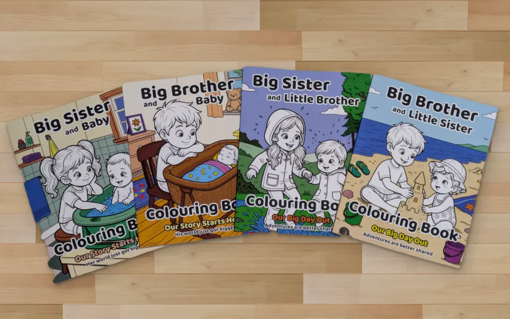 The four Happy Crayon Studios colouring books fanned out on a wooden floor: Big Sister and Baby, Big Brother and Baby, Big Sister and Little Brother, and Big Brother and Little Sister